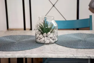 a vase with a plant in it sitting on a table at Casa Elafonisi N2-10min from the beach in Plokamianá
