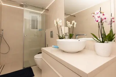 a bathroom with a sink and a toilet and a shower at Belle Verte City Chania in Chania Town