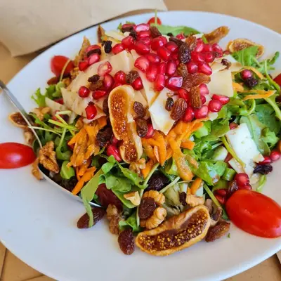 a salad on a white plate on a table at Belle Verte City Chania in Chania Town