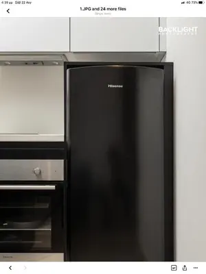 a black refrigerator in a kitchen next to a microwave at Chania Center Apartment in Chania Town