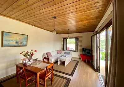 a living room with a couch and a table at Nikos Traditional House in Maláthiros