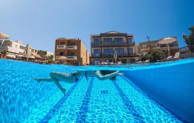 two people are swimming in a swimming pool at Giannarakis Beach in Stalos