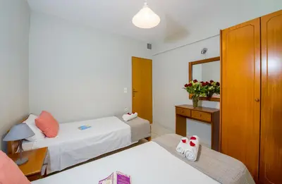 a hotel room with two beds and a mirror at Giannarakis Beach in Stalos