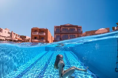 a woman is swimming in a swimming pool at Giannarakis Beach in Stalos