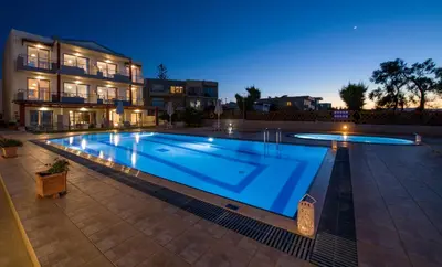a large swimming pool in front of a building at Giannarakis Beach in Stalos