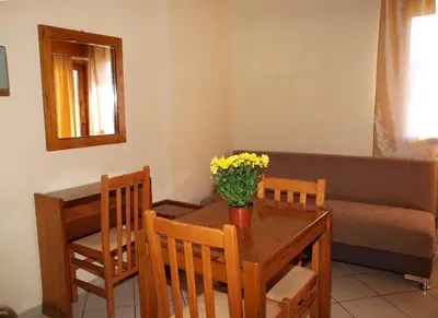 a living room with a table and a couch at Kato Stalos Mare in Stalos