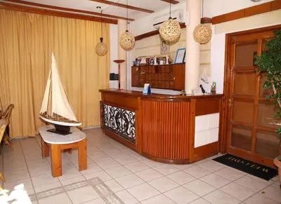 a room with a shop with a table and a bench at Kato Stalos Mare in Stalos