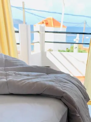 a bed sitting on top of a balcony at Ouranos Studios in Kalamaki Chanion