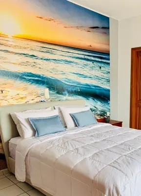 a bedroom with a bed with a painting of the ocean at Ouranos Studios in Kalamaki Chanion