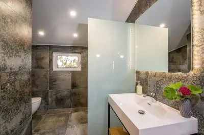 a bathroom with a sink and a toilet and a mirror at Casa di Goya in Chania Town