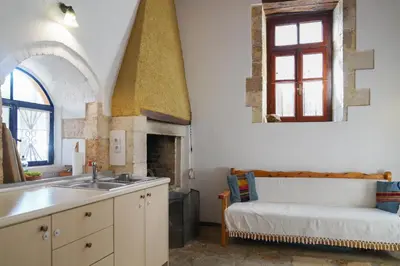 a kitchen with a sink and a fireplace at Lindas Convent Garden Home 4 in Chania Town
