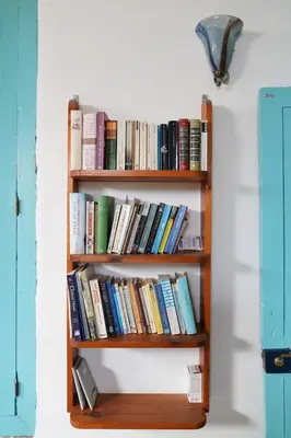 a book shelf filled with books on a wall at Lindas Convent Garden Home 4 in Chania Town