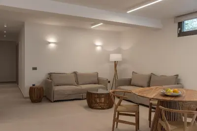 a living room with a couch and a table at Amalthia Villa, Heated Pool & Walk to the Beach, By ThinkVilla in Tavronitis