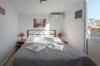 a bedroom with a bed with towels on it at Calliope Rooms in Kissamos