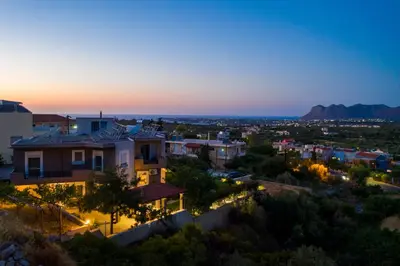 a view of a city at night at Tholos Apartments in Chania Town