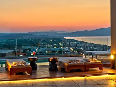 a room with two tables and a view of a city at Alectrona Living Crete, Apartment RocSea in Plataniás
