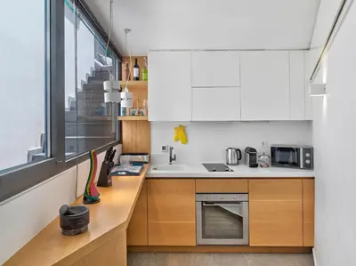 a kitchen with white cabinets and a sink and a window at Alectrona Living Crete, Apartment RocSea in Plataniás