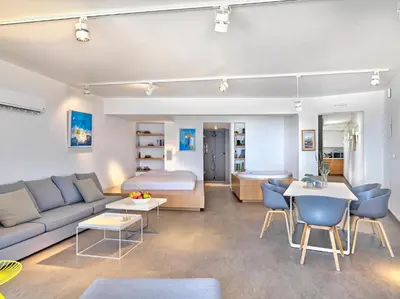 a living room with a couch and a bed at Alectrona Living Crete, Apartment RocSea in Plataniás