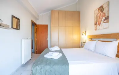 a bedroom with a bed with two towels on it at Sofia's seaview house in Plataniás