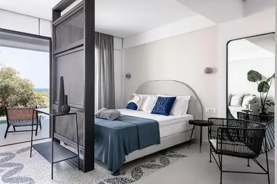 a bedroom with a bed and a balcony at Nuovo Luxury Suites in Daratso