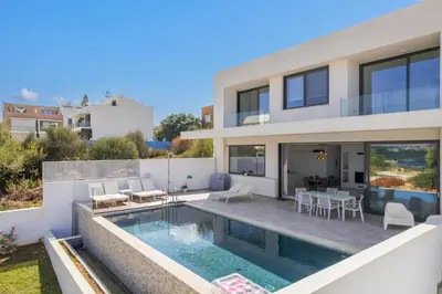 a villa with a swimming pool and a house at Villa Valentina Chania in Kalathas