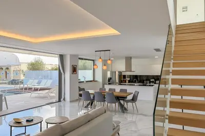 an open kitchen and dining room with a table and chairs at Villa Valentina Chania in Kalathas