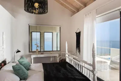 a living room with a couch and a large window at Seacrete villas in Chania Town