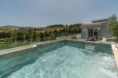 a swimming pool in the backyard of a house at Villa Eftychia - villa with 2 private pools!!! by PosarelliVillas in Almirida