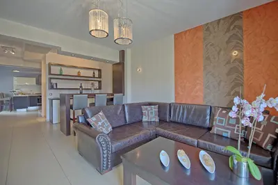 a living room with a couch and a table at Cabanavillas MILANO by PosarelliVillas in Agia Marina Nea Kydonias