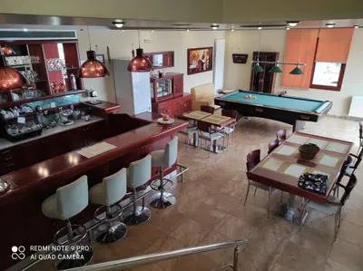 a restaurant with a pool table and a bar at Villa Koulouridi Agritourism in Daratso