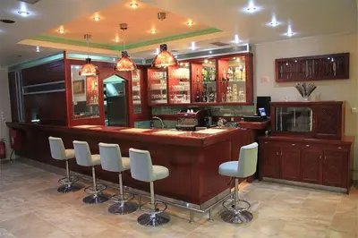 a bar with white stools in a room at Villa Koulouridi Agritourism in Daratso