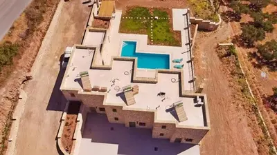 an overhead view of a large house with a swimming pool at Mitato Stylianos in Kounoupítsa
