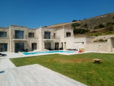a large stone building with a swimming pool at Mitato Stylianos in Kounoupítsa