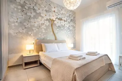 a bedroom with a bed with a flower wall at Casa Gardenia-modern apartment next to the beach, near Old Town in Chania Town