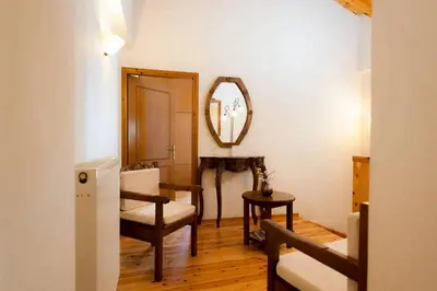a living room with a chair and a mirror at Villa Kirke in Próvarma