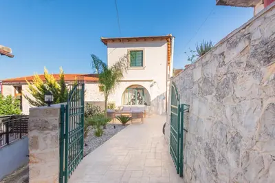 a gate to a house with a stone wall at Villa Kirke in Próvarma