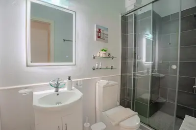 a bathroom with a toilet and a sink and a shower at Villa Marianne in Chania Town