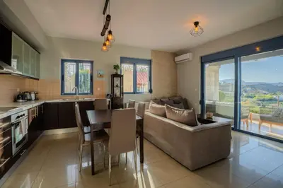 a kitchen and living room with a couch and a table at Villa Marianne in Chania Town
