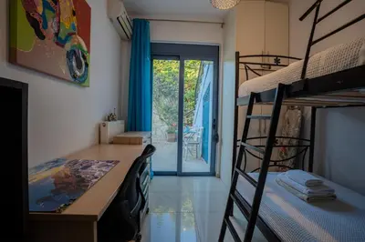 a bedroom with a bunk bed and a desk and a bunk bedessen at Villa Marianne in Chania Town