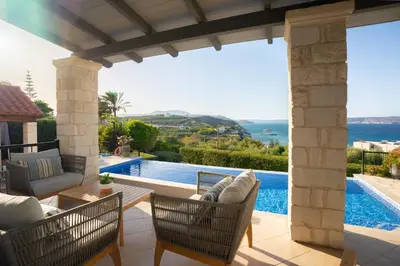a patio with a view of a swimming pool at Villa Marianne in Chania Town