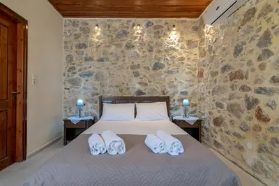 a bedroom with a bed with two towels on it at Archodiko Villa Imbros in Ímbros