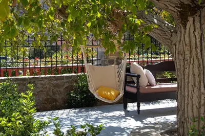 a hammock hanging from a tree in a garden at Archodiko Villa Imbros in Ímbros