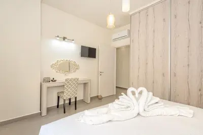 a bedroom with a white bed and a desk at SUNRISE Spacious Apartment With 3 Bedrooms & 3 Bathrooms -Near to Chania in Kolymvari