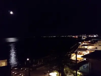 a view of the ocean at night with the moon at SUNRISE Spacious Apartment With 3 Bedrooms & 3 Bathrooms -Near to Chania in Kolymvari