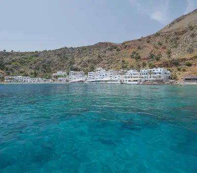 a view of the water in front of a cluster of white buildings at SUNRISE Spacious Apartment With 3 Bedrooms & 3 Bathrooms -Near to Chania in Kolymvari