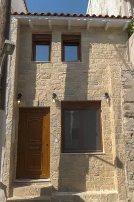 a building with a brown door and three windows at Mezoneta 