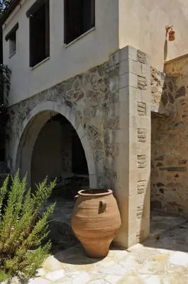 a large vase sitting in front of a building at Sarris House in Xirokámbion