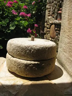 a stone bowl sitting on top of a rock at Sarris House in Xirokámbion