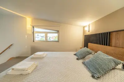 a bedroom with a large bed with two pillows on it at Villa Jarko in Chania Town
