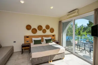 a bedroom with a bed and a balcony at Ilingas Mare in Khóra Sfakíon
